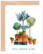 Front view of an encouraging 'You Grow Girl' birthday greeting card for her, featuring a beautiful watercolor illustration of various potted green plants and trees with a small 'love' sign. Perfect for a friend.