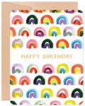 Vibrant watercolor rainbow patterned greeting card with 'HAPPY BIRTHDAY' in gold text on the front, next to a kraft envelope.