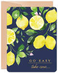 Vibrant watercolor lemon greeting card with green leaves on a dark blue background, featuring 'GO EASY take care...' in elegant script. Perfect for encouraging someone to feel better.