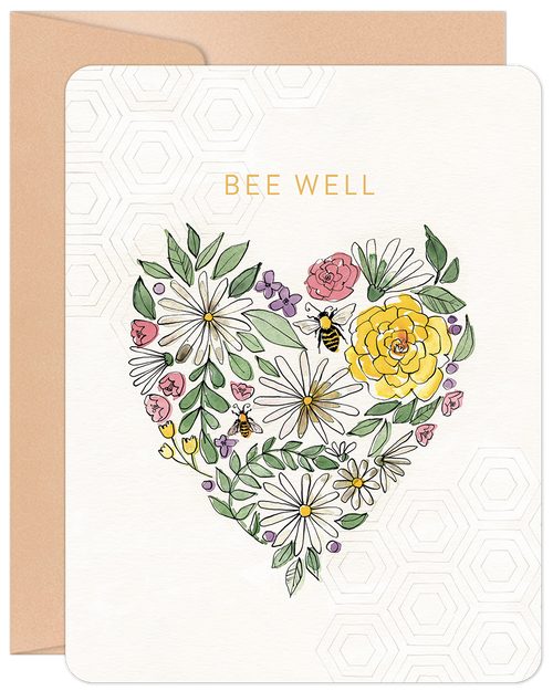 Front of a 'Bee Well' get well card featuring a watercolor heart design made of white daisies, yellow roses, purple flowers, green leaves, and two bumblebees on a cream background with a subtle honeycomb pattern. A kraft envelope is partially visible behind.