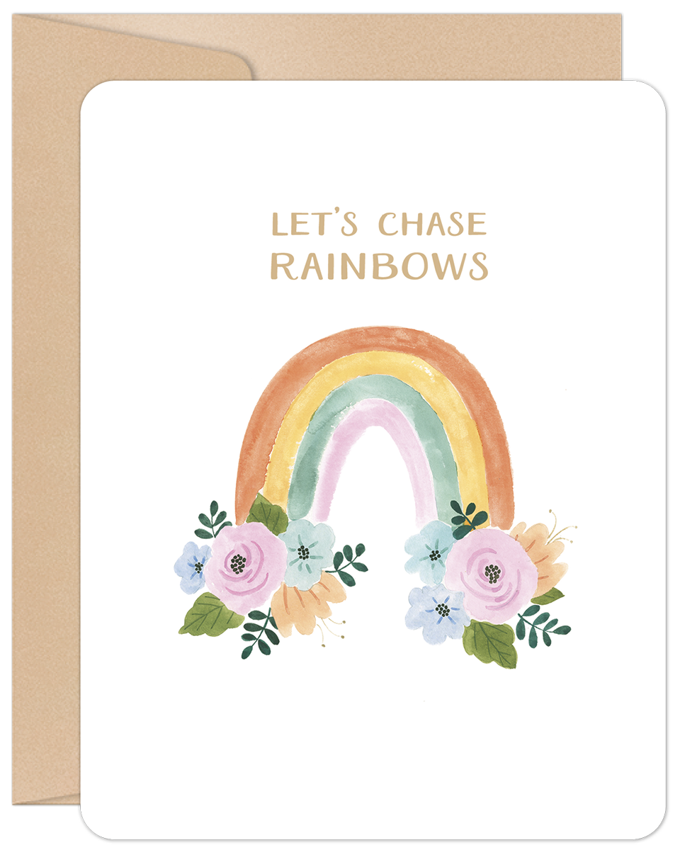 White greeting card with a watercolor rainbow and pink and blue flowers, text 'LET'S CHASE RAINBOWS', and a kraft envelope.