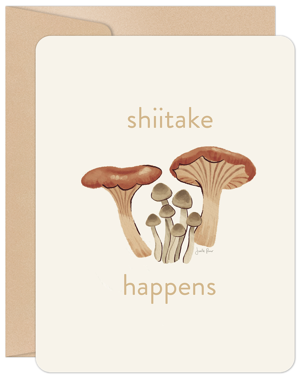 Front of an encouragement card with 'shiitake happens' text and an illustration of various brown and tan mushrooms.