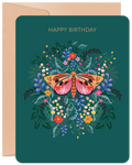 Elegant dark teal birthday greeting card featuring a vibrant orange and pink moth or butterfly surrounded by intricate purple, red, yellow, and green floral botanical illustrations. The card front reads 'HAPPY BIRTHDAY' in gold, presented with a rustic kraft envelope.