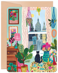 SEO-optimized alt description for a greeting card featuring a vibrant illustration of a cozy indoor scene. A black cat sits on a patterned sofa, looking out a window at a city skyline. The room is decorated with numerous potted plants, macrame hangers, colorful lamps, and framed artwork, creating a cheerful, artistic, and inviting atmosphere. The card has rounded corners and a brown envelope visible behind it.