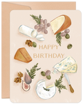Elegant birthday greeting card featuring a detailed watercolor illustration of a charcuterie board with various gourmet cheeses like brie, blue cheese, and cheddar, alongside green grapes, dark figs, green olives, walnuts, and a cheese knife, all on a light peach background with 'HAPPY BIRTHDAY' text. Perfect for food lovers.