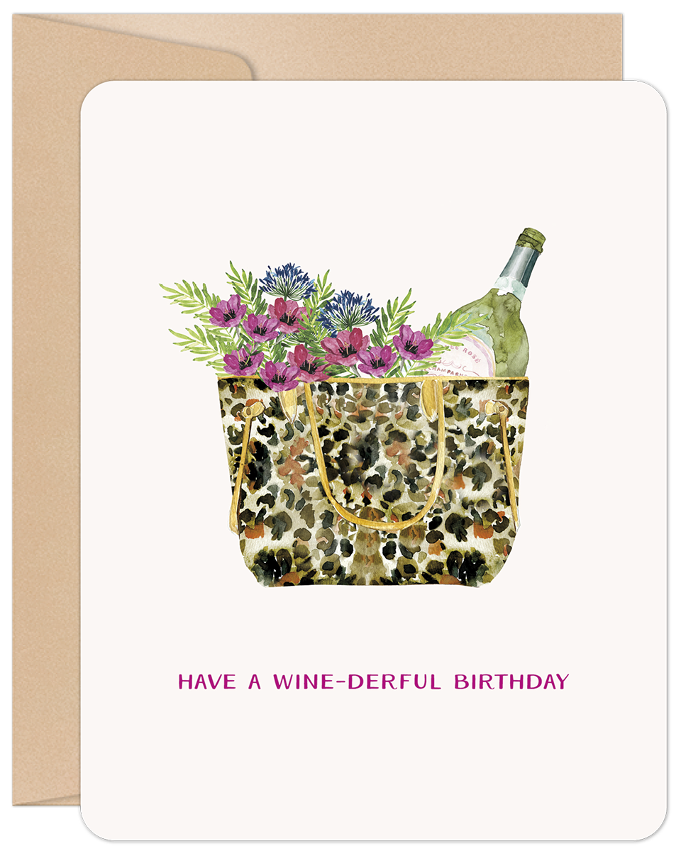 Watercolor illustration of a leopard print tote bag overflowing with vibrant purple and pink flowers, greenery, and a bottle of sparkling wine. The text 'HAVE A WINE-DERFUL BIRTHDAY' is printed below, set against a light background with a kraft brown envelope peeking out.