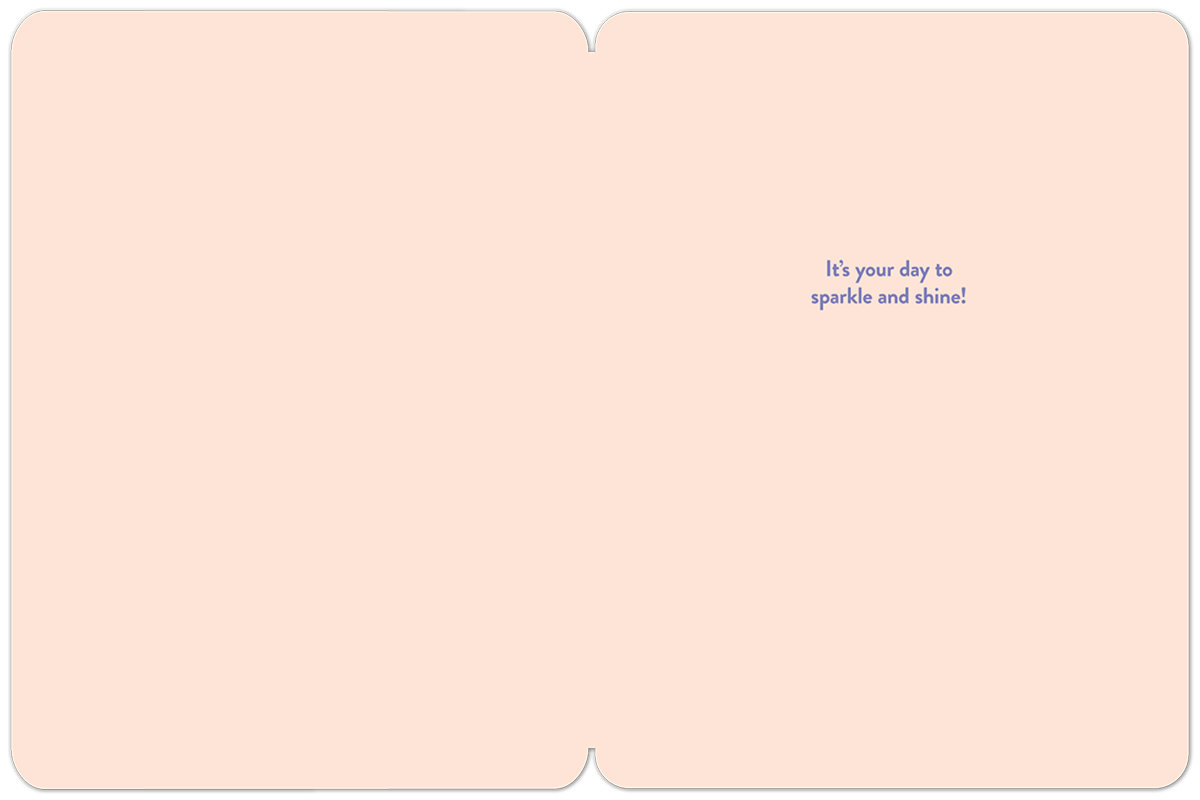 Inside view of a light pink greeting card with a simple, elegant dark blue message on the right side reading: 'It's your day to sparkle and shine!' providing space for a personal handwritten note.