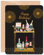 Elegant black birthday greeting card with golden fireworks, a festive bar cart featuring a cake, champagne bucket with bottles, various cocktails, and liquor bottles. Text reads 'Happy Birthday!'. Perfect for a celebratory occasion.