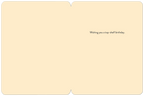 Interior view of an open cream-colored greeting card with the message 'Wishing you a top-shelf birthday.' printed in black script on the right side, conveying a witty and celebratory sentiment.