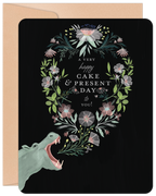 Whimsical hippo greeting card for celebration, featuring an elegant floral wreath on a black background and a beige kraft envelope.