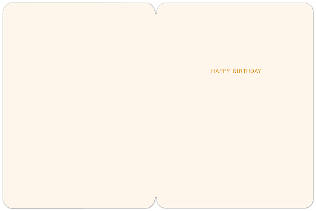 Inside of a cream-colored birthday greeting card, with 'HAPPY BIRTHDAY' printed in a subtle gold font on the right-hand side, leaving ample space for a personalized message.