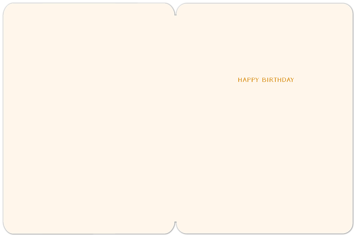 Inside of a cream-colored birthday greeting card, with 'HAPPY BIRTHDAY' printed in a subtle gold font on the right-hand side, leaving ample space for a personalized message.