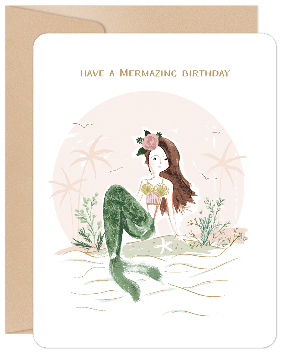 Charming mermaid greeting card for kids featuring a whimsical illustration of a brown-haired mermaid with a floral crown and green tail, sitting on a sandy beach with palm trees, wishing 'Have a Mermazing Birthday'.
