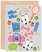 Vibrant, illustrated greeting card featuring various fitness items like blue running shoes, pink dumbbells, a tennis racket, green jump ropes, water bottle, a 'FITNESS 4U' book, a pink gym bag, tennis balls, apples, and white socks, with 'HAPPY BIRTHDAY' and 'BUT FIRST, GYM...' text, set against a light grey background.