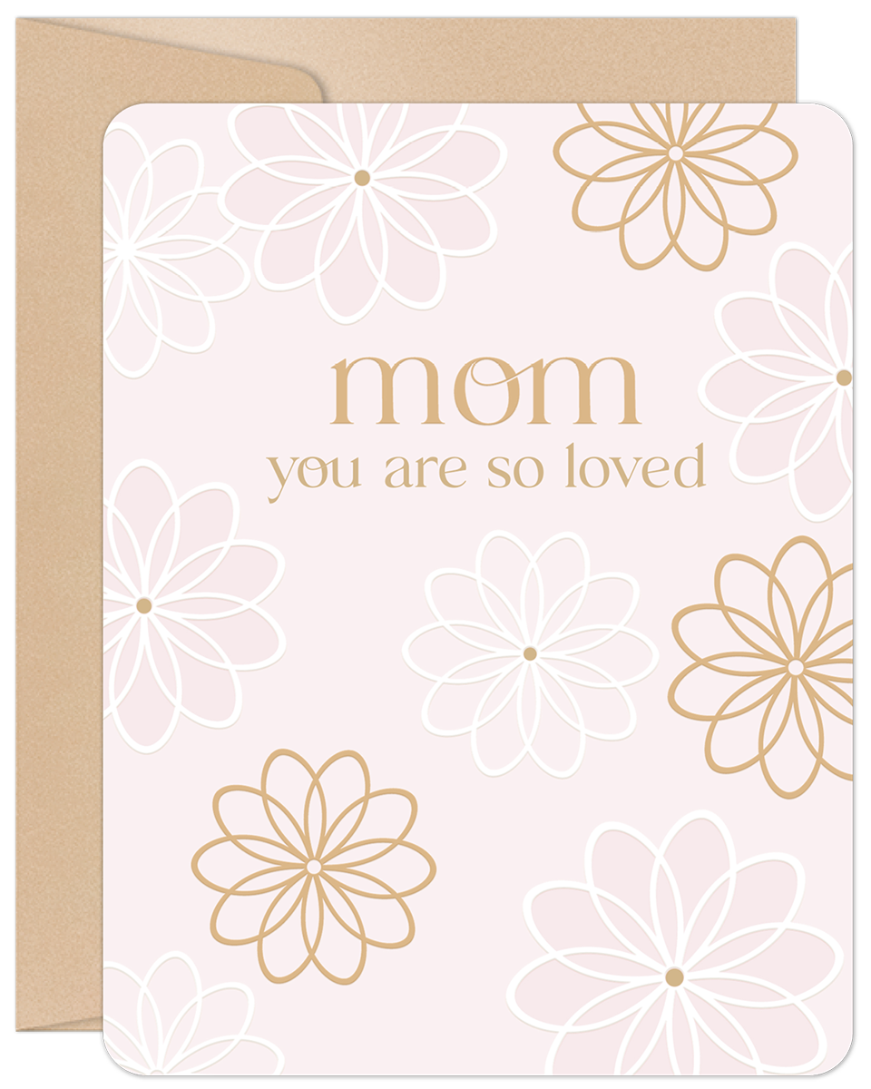 Elegant pink greeting card for a mom, featuring 'Mom you are so loved' in gold text, delicate white and gold floral outlines, with a visible kraft envelope.