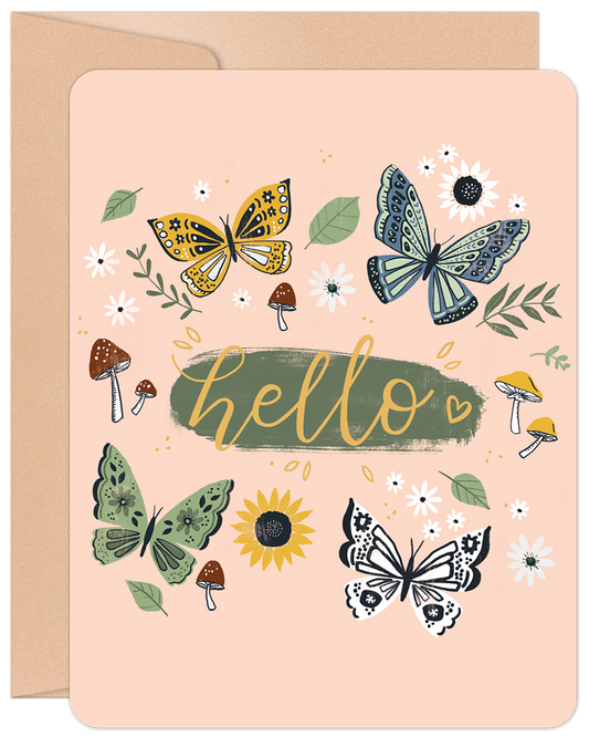Front of a charming greeting card featuring colorful butterflies, whimsical mushrooms, and scattered flowers with 'hello' in cursive on a light pink background.