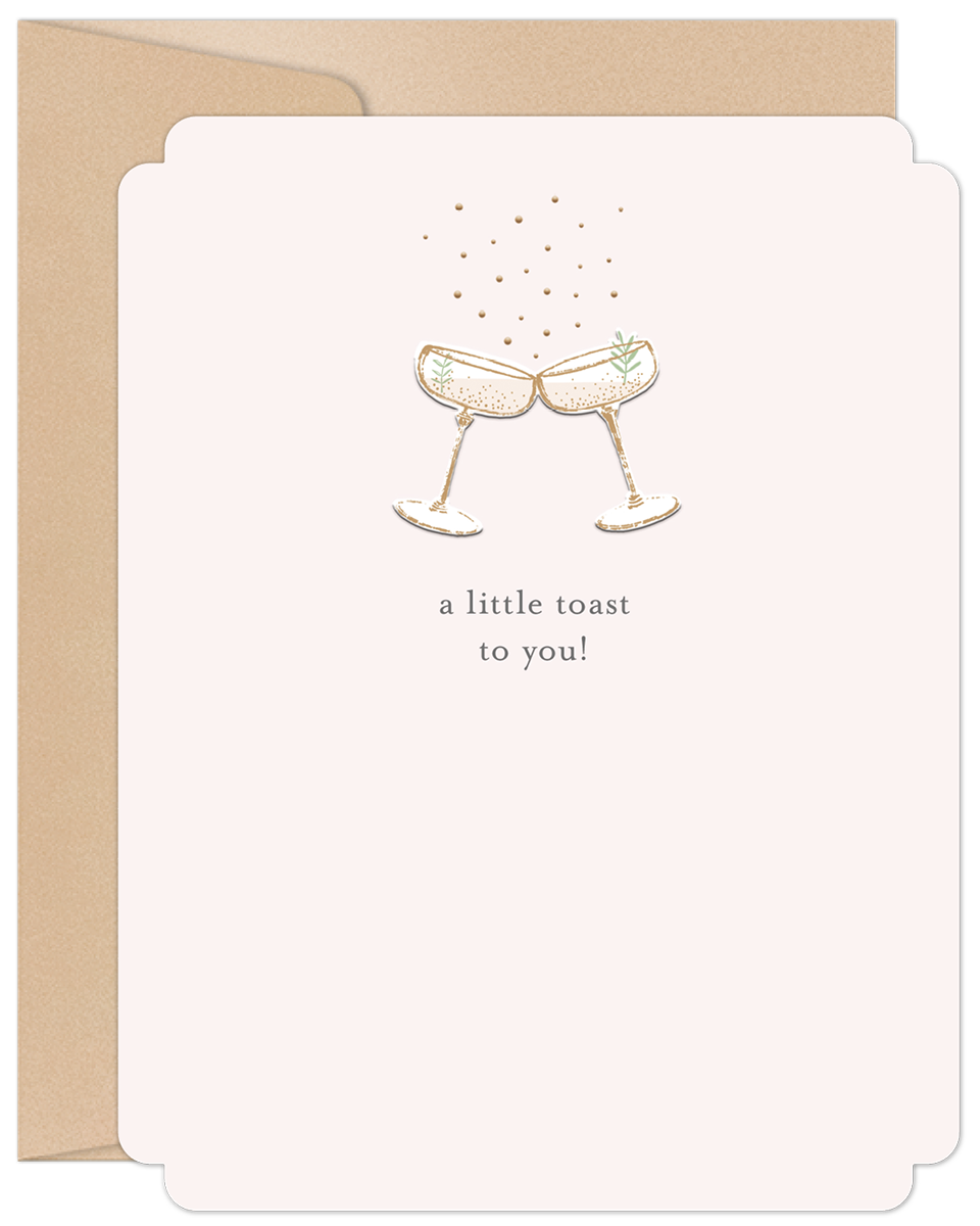 Elegant anniversary card featuring two champagne glasses toasting with sparkling gold accents on a blush pink background, text reads 'a little toast to you!'