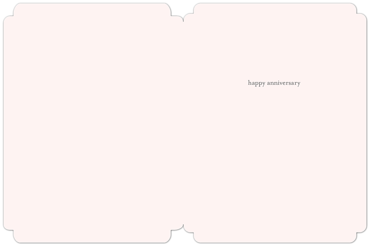 Inside of a light pink anniversary greeting card with elegant rounded corners, subtle text reads 'happy anniversary' in a minimalist font.