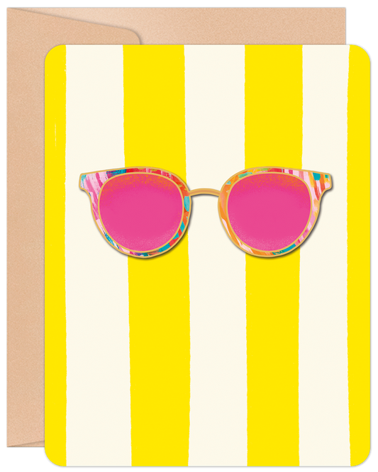 Front of a cheerful blank greeting card featuring bold yellow and white stripes with a die-cut illustration of pink-lensed sunglasses.