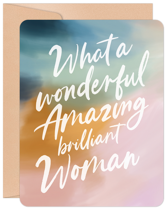 Front of a greeting card with 'What a wonderful Amazing brilliant Woman' in white calligraphy over a pastel watercolor background of blue, gold, and pink.