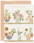 Elegant watercolor floral get well soon greeting card for friends, featuring blooming flowers in various vases on a soft cream background, paired with a craft paper envelope.