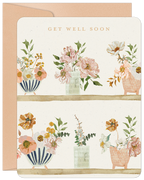 Elegant watercolor floral get well soon greeting card for friends, featuring blooming flowers in various vases on a soft cream background, paired with a craft paper envelope.