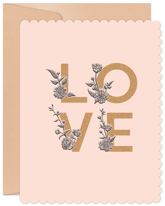 Close-up of a pink greeting card with a scalloped edge, featuring the word 'LOVE' in gold lettering intertwined with elegant grey floral illustrations, accompanied by a kraft envelope.