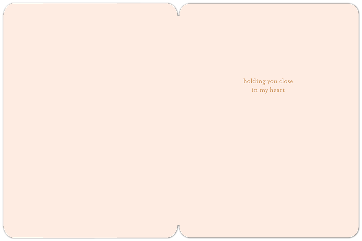 Inside of a light peach sympathy card with text 'holding you close in my heart' on the right side.
