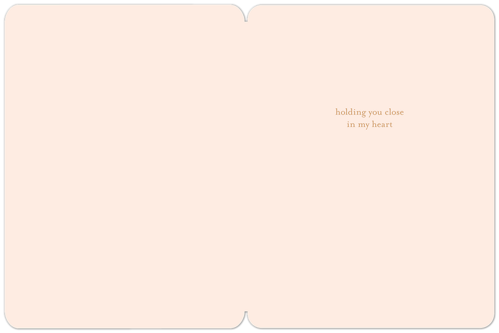 Inside view of a gentle cream-colored sympathy card, revealing the deeply comforting message 'holding you close in my heart' in elegant script, conveying warmth and support.