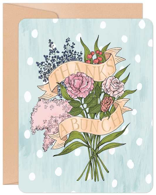 Front of a 'Thanks a Bunch' greeting card featuring a bouquet of pink roses, blue berries, and light pink flowers on a light blue polka dot background with a kraft envelope behind.