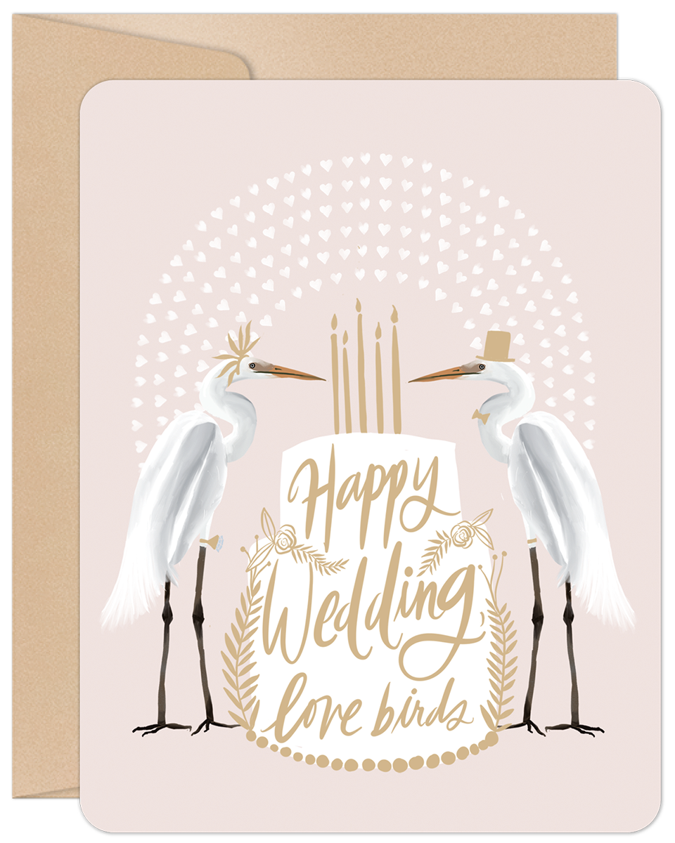 Happy Wedding Love Birds greeting card featuring two egrets dressed as bride and groom with a wedding cake, on a pink background.