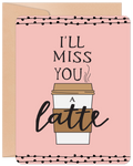 Front of a funny 'I'll Miss You A Latte' greeting card with a coffee cup design on a light pink background, bordered by black polka dots, accompanied by a kraft envelope.