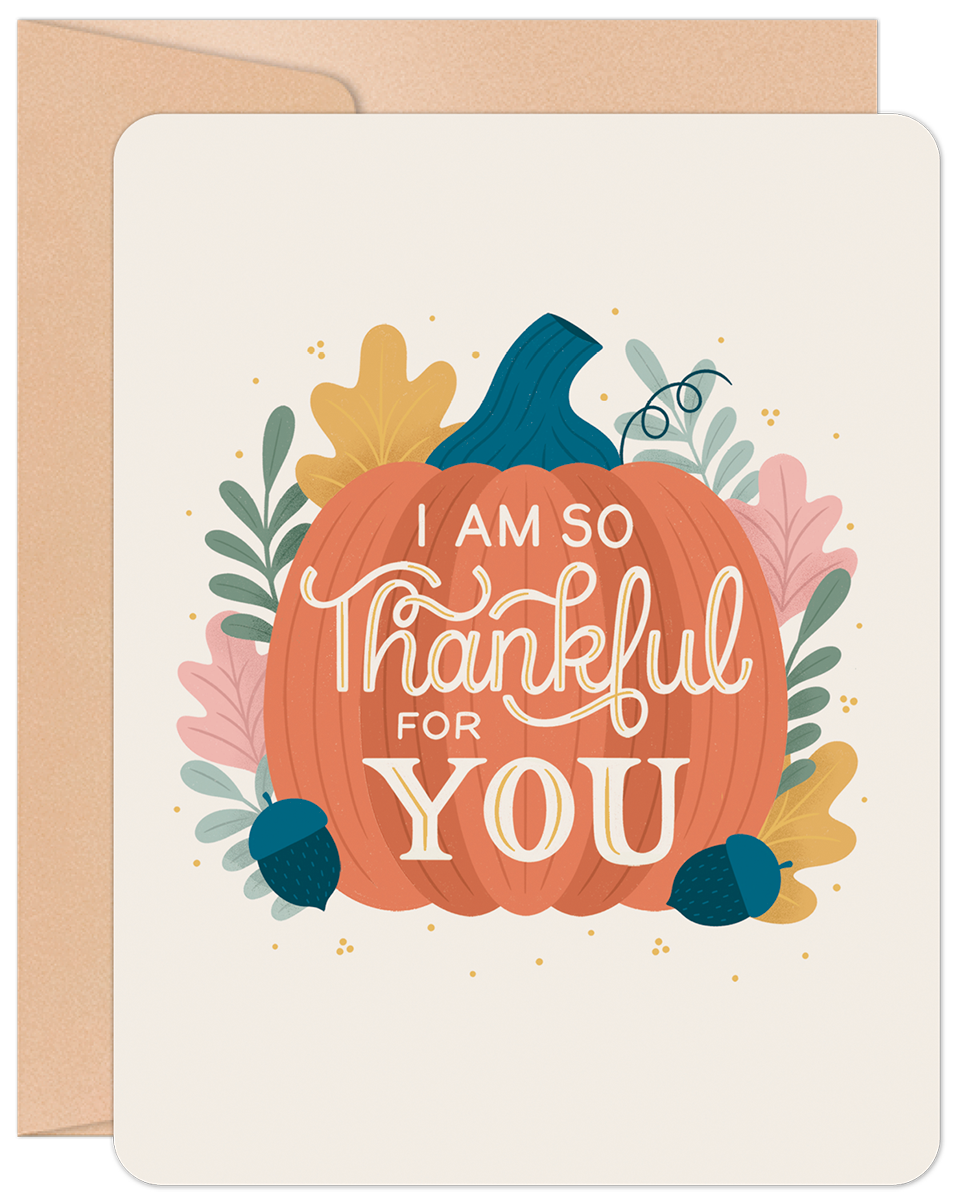 Front of a 'Thankful for You Pumpkin' greeting card with a vibrant pumpkin illustration and fall leaves on a cream background, with a kraft envelope visible.