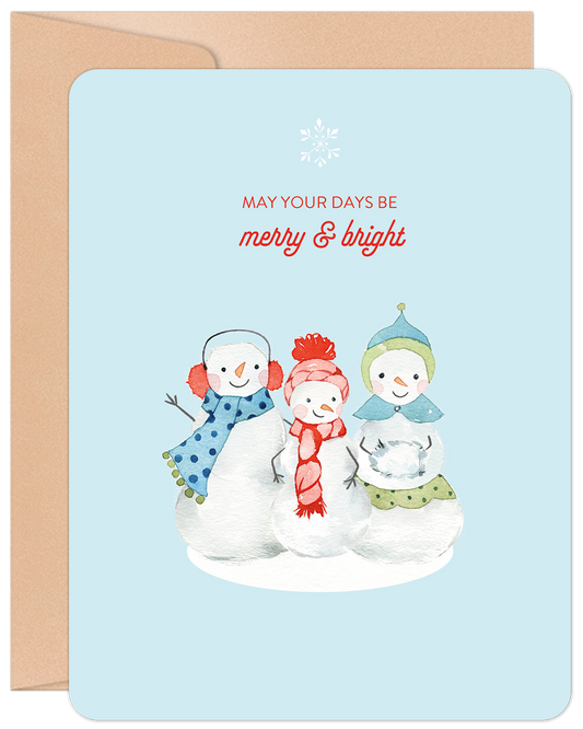 Front of a light blue Christmas card featuring three watercolor snowmen and the text 'MAY YOUR DAYS BE merry & bright'.