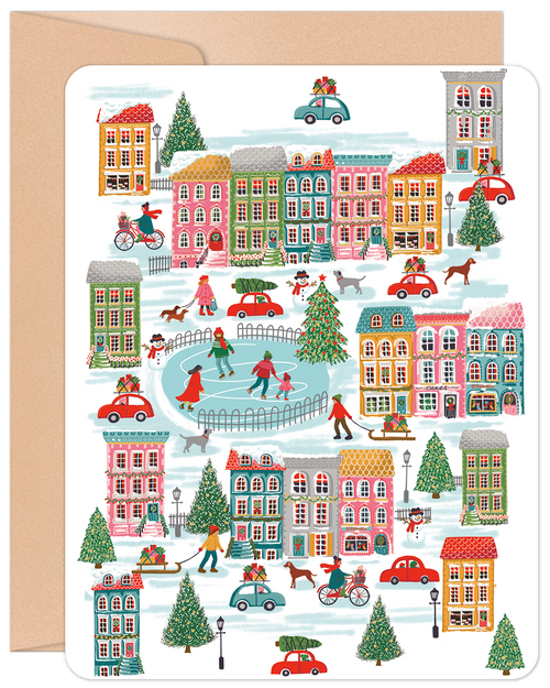 Whimsical holiday town scene greeting card featuring ice skaters, families, carolers, and festive houses with snow and decorated trees.