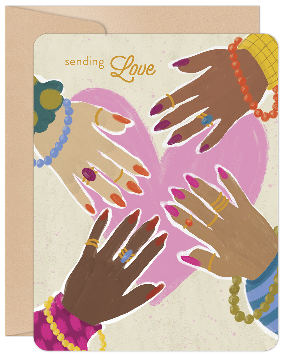 Front of a heartfelt encouragement greeting card featuring diverse hands adorned with jewelry, forming a pink heart. The text 'sending Love' is visible. A kraft envelope is partially seen behind it. Ideal for a friend needing support.