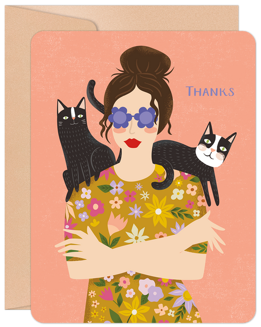 Front of a thank you card featuring a stylish woman with a bun, blue sunglasses, and two black cats perched on her shoulders. 'THANKS' is written on the right.
