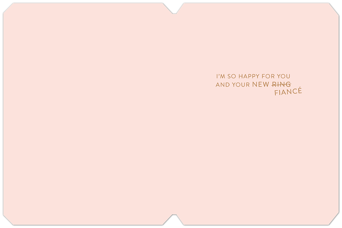 Inside view of a heartfelt engagement card, displaying 'I'M SO HAPPY FOR YOU AND YOUR NEW RING FIANCÉ' in elegant gold script on a light pink background.