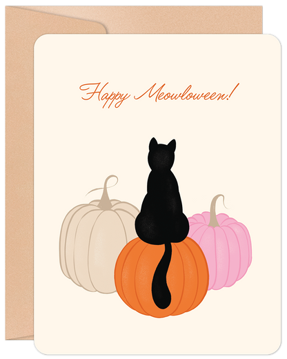 Happy Meowloween greeting card featuring a black cat sitting on an orange pumpkin, flanked by pink and cream pumpkins.