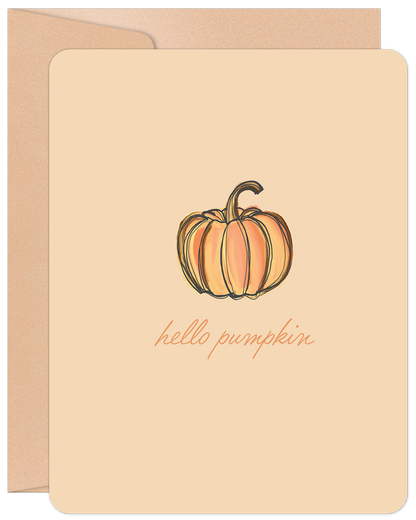Front of a 'Hello Pumpkin' greeting card featuring a hand-drawn orange pumpkin illustration on a light tan background, with a kraft envelope behind it.