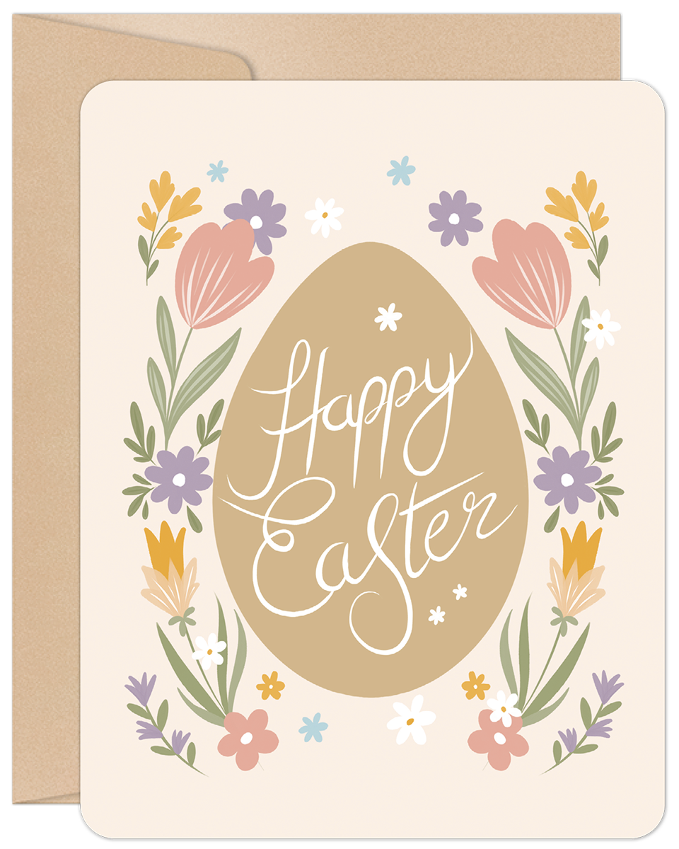 Front of a cute Easter greeting card featuring a central brown egg with 'Happy Easter' in white script, framed by colorful floral elements including pink tulips, yellow and purple flowers, and green leaves. A kraft paper envelope is visible behind the card.
