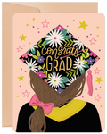 Vibrant floral graduation greeting card featuring an illustrated student in a black cap and gown with 'Congrats Grad' in gold text, surrounded by stars and confetti on a blush pink background, perfect for celebrating a special achievement.