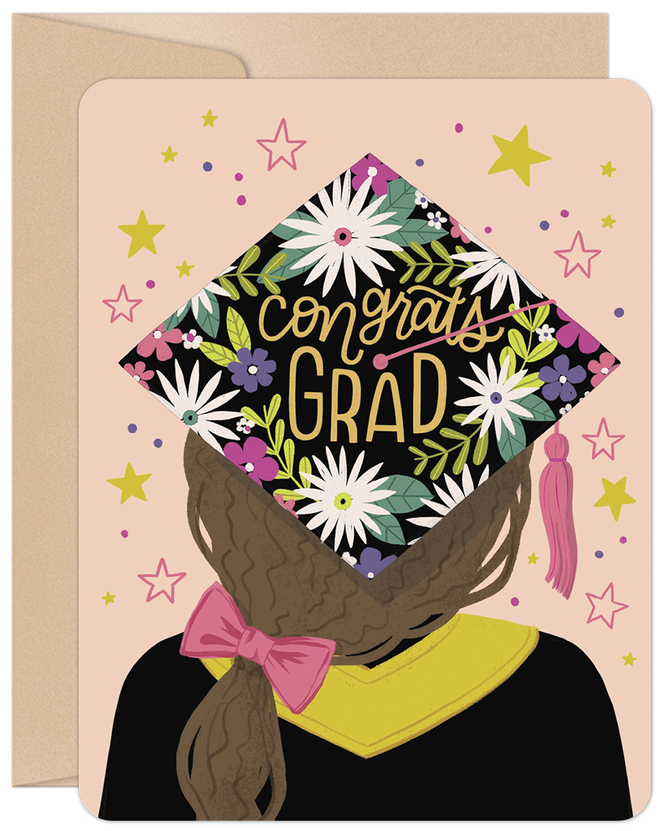 Front of a graduation card featuring a grad girl from behind, wearing a floral 'Congrats Grad' cap, on a pink background with stars.