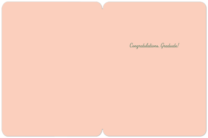 Inside of a light peach graduation card with 'Congratulations. Graduate!' in green script on the right side.