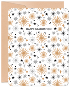 Front view of an inspiring graduation greeting card featuring gold, silver, and black starbursts on a white background, next to a kraft paper envelope. The card reads 'HAPPY GRADUATION'.