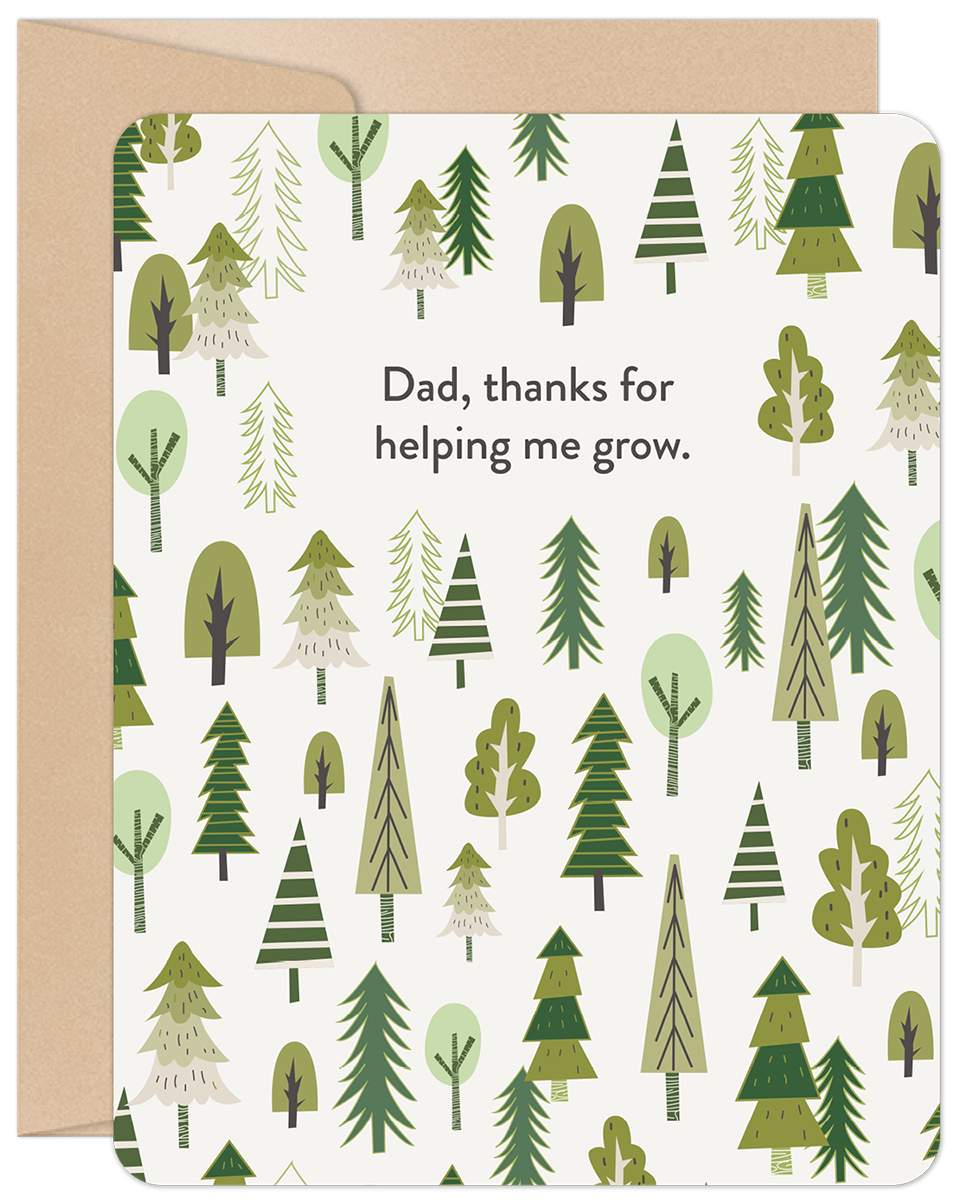 Front of a Father's Day greeting card featuring a whimsical forest of green evergreen and deciduous trees on a cream background. The text reads 'Dad, thanks for helping me grow.' A rustic kraft paper envelope is visible behind the card.