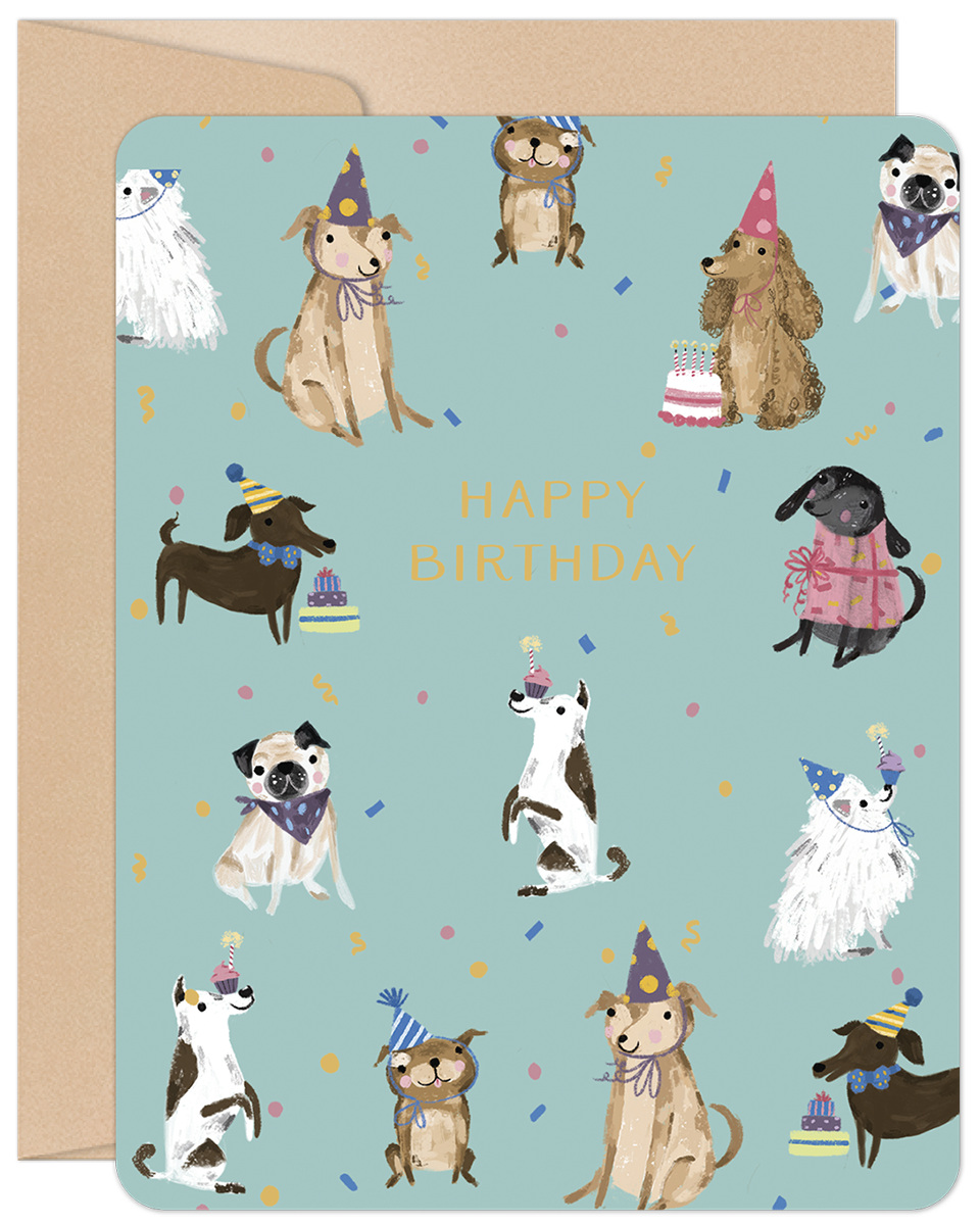 Greeting card front with a cheerful turquoise background, featuring a diverse group of cartoon dogs wearing colorful party hats, surrounded by confetti and small birthday cakes. Text reads 'HAPPY BIRTHDAY'.