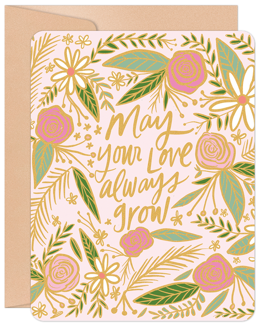Front of a pink anniversary card with gold foil and green floral design, featuring "May your love always grow" text.