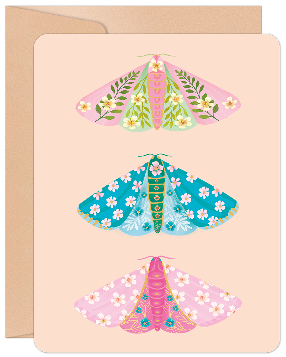 Greeting card featuring three colorful floral moths in pink, blue, and green on a peach background with a kraft envelope.