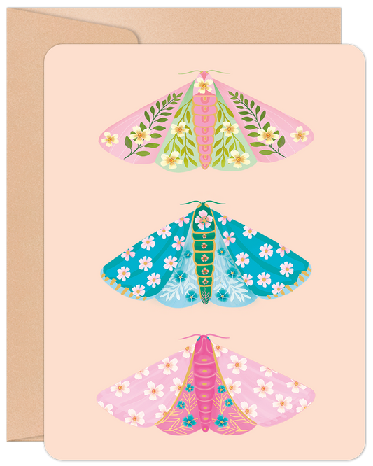 Greeting card featuring three colorful floral moths in pink, blue, and green on a peach background with a kraft envelope.